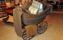 A victorian pram of cushions in the Interiors gallery at Cotswold Woollen Weavers